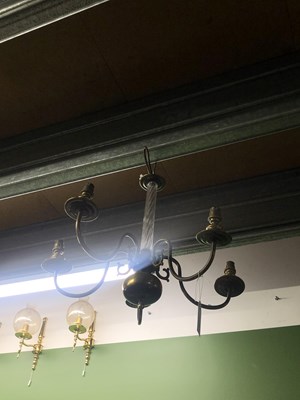 Lot 706 - A five armed brass chandelier with a glass stem.