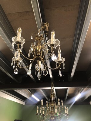Lot 713 - A five armed crystal and metal chandelier.