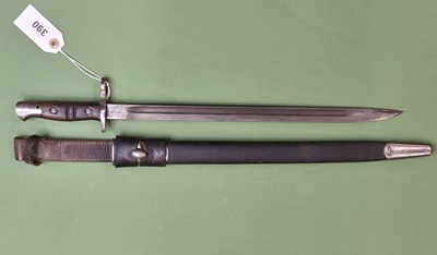 Lot 390 - A 1917 Remington bayonet in a Garstin leather...
