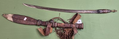 Lot 391 - An African single edged curved sword with a...