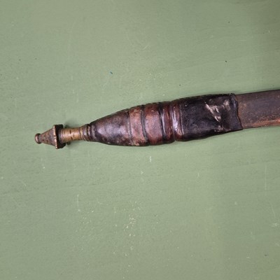 Lot 391 - An African single edged curved sword with a...
