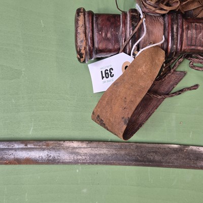 Lot 391 - An African single edged curved sword with a...