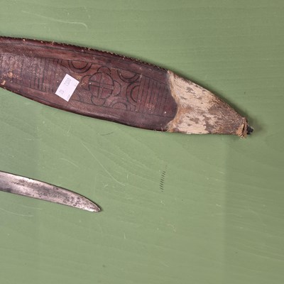 Lot 391 - An African single edged curved sword with a...