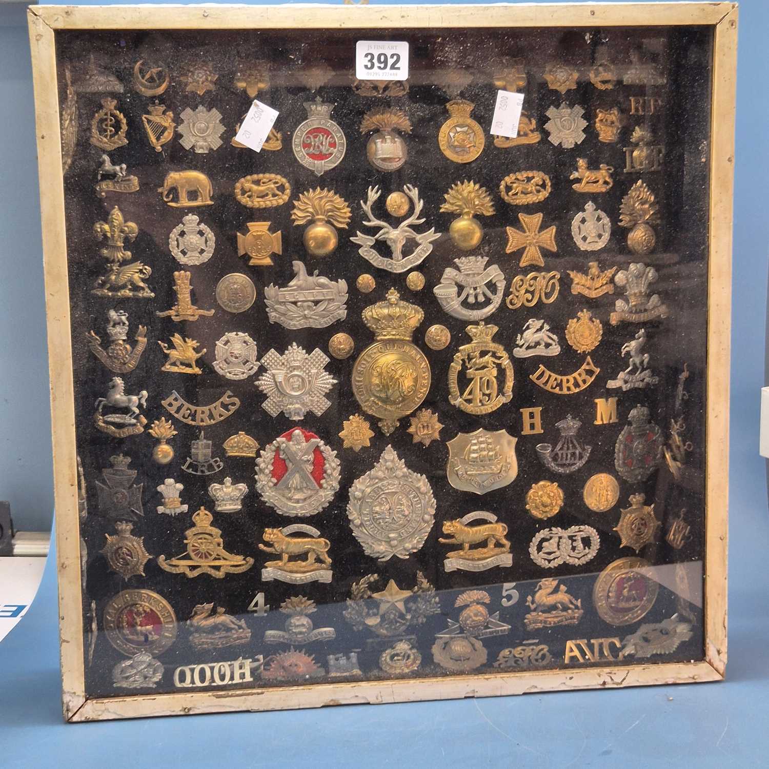Lot 392 - Two glazed wall display cases of military cap...