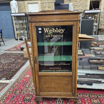 Lot 613 - A vintage Oak display cabinet with glazed door...
