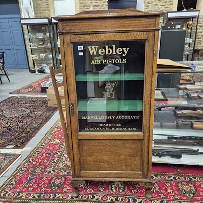 Lot 613 - A vintage Oak display cabinet with glazed door...