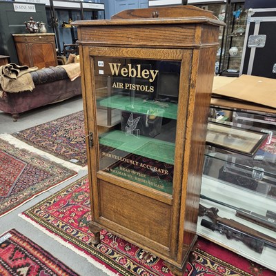 Lot 613 - A vintage Oak display cabinet with glazed door...