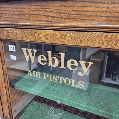 Lot 613 - A vintage Oak display cabinet with glazed door...