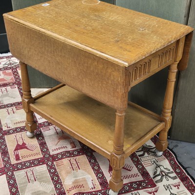 Lot 106 - An Arts and Crafts oak flap top two tier...