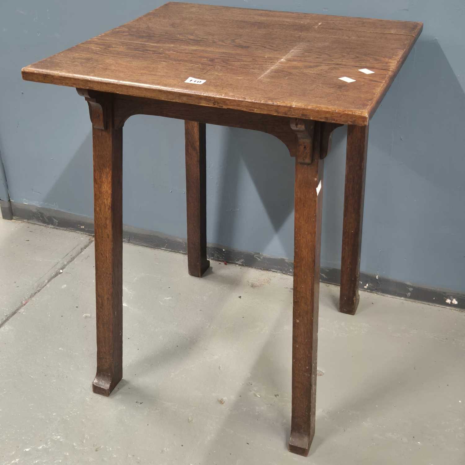 Lot 110 - An Arts and Crafts oak table supported on four...