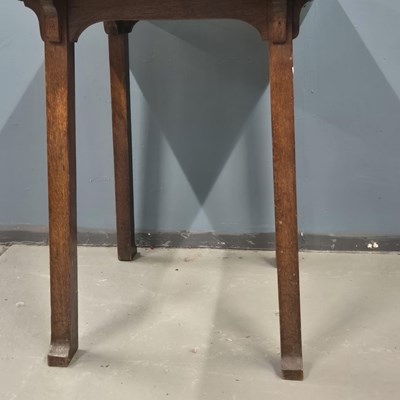 Lot 110 - An Arts and Crafts oak table supported on four...