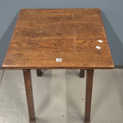 Lot 110 - An Arts and Crafts oak table supported on four...