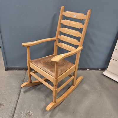Lot 113 - An Arts and Crafts oak ladder back rocking...