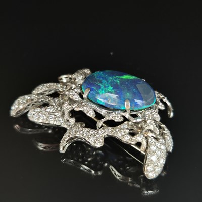 Lot 81 - A boulder opal and diamond pendant brooch....