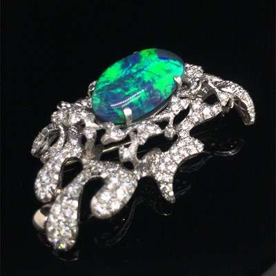 Lot 81 - A boulder opal and diamond pendant brooch....