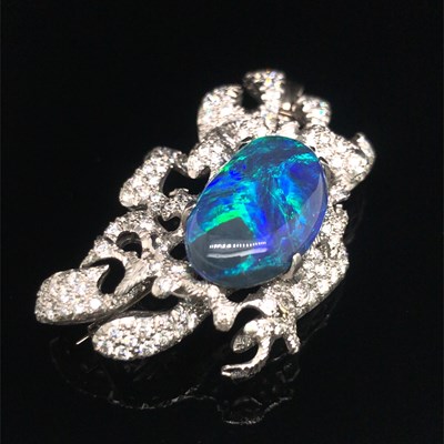 Lot 81 - A boulder opal and diamond pendant brooch....