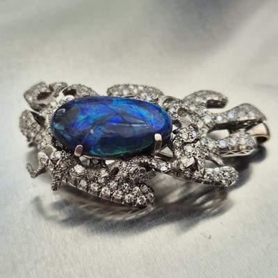 Lot 81 - A boulder opal and diamond pendant brooch....