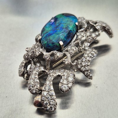 Lot 81 - A boulder opal and diamond pendant brooch....