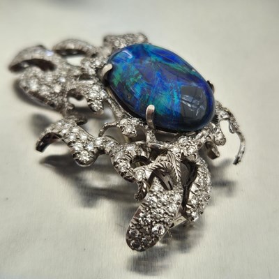 Lot 81 - A boulder opal and diamond pendant brooch....