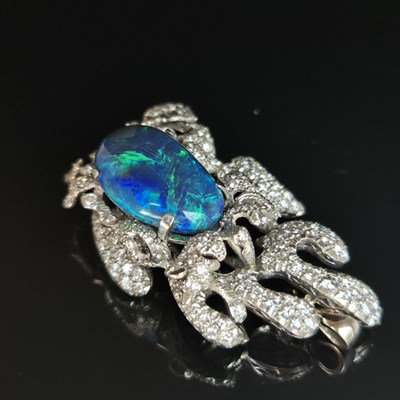 Lot 81 - A boulder opal and diamond pendant brooch....