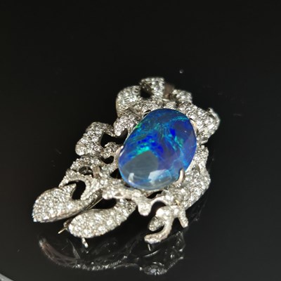 Lot 81 - A boulder opal and diamond pendant brooch....