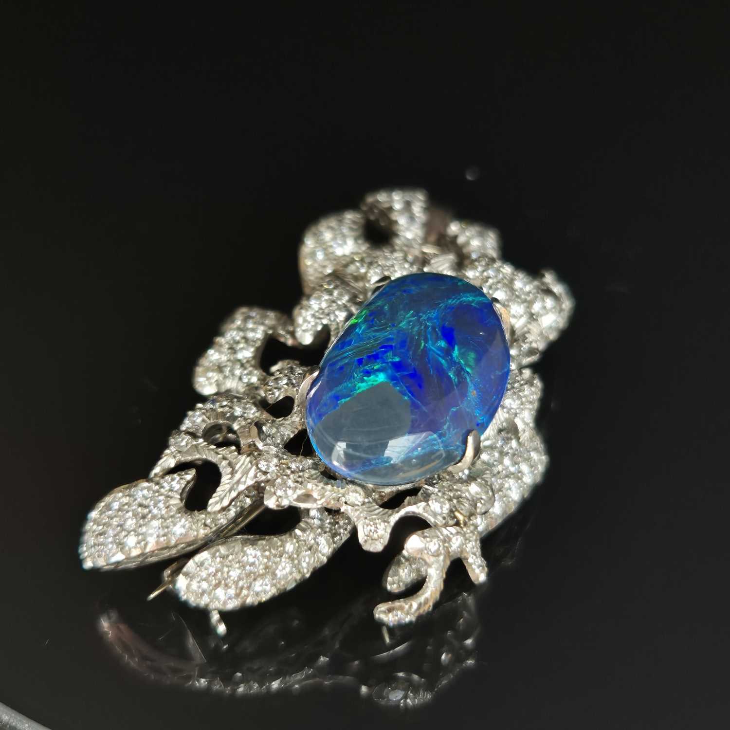 Lot 81 - A boulder opal and diamond pendant brooch....