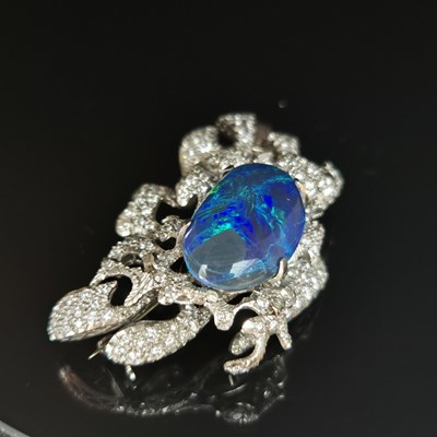 Lot 81 - A boulder opal and diamond pendant brooch....