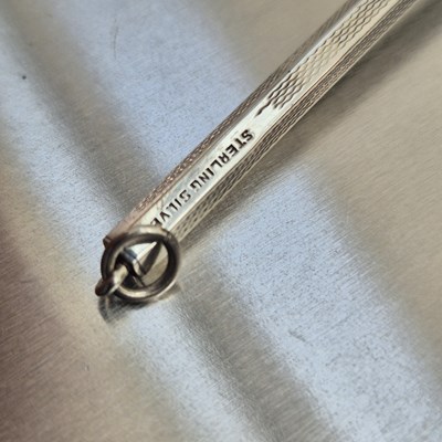 Lot 83 - A vintage swizzle stick stamped sterling...