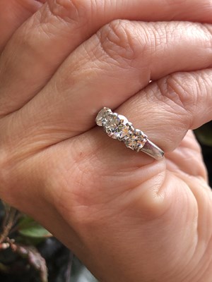Lot 84 - A platinum hallmarked three-stone diamond,...