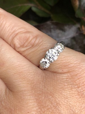 Lot 84 - A platinum hallmarked three-stone diamond,...