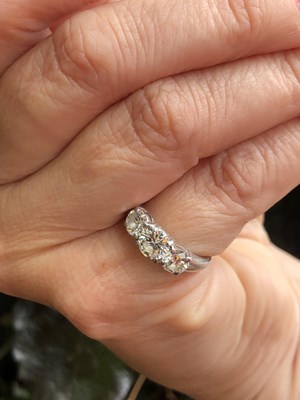Lot 84 - A platinum hallmarked three-stone diamond,...