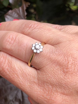 Lot 91 - An 18ct hallmarked gold diamond cluster ring....