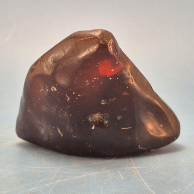 Lot 122 - A triangular shaped amber pebble.   W 11cms.