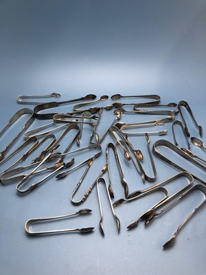 Lot 125 - Thirty three silver sugar tongs, 737Gms