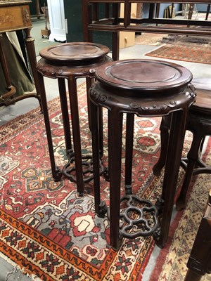 Lot 128 - A pair of Chinese hardwood urn stands.