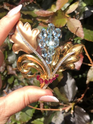 Lot 100 - A vintage diamond, ruby, and aquamarine ornate...