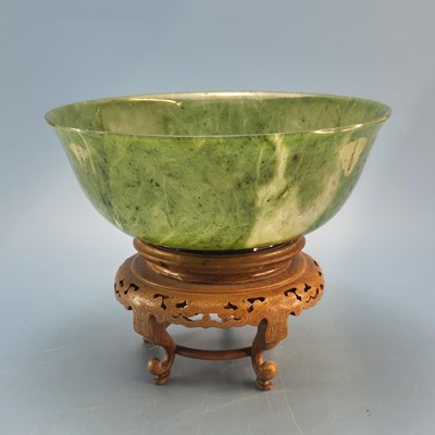 Lot 160 - A Chinese mottled spinach green hardstone bowl...