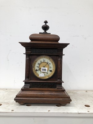 Lot 705 - An oak cased mantle clock striking on a coiled...