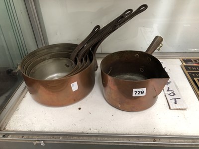 Lot 729 - A nest of five copper saucepans together with...