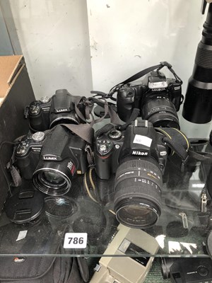 Lot 786 - Lumix and Nikon cameras, lenses and cases with...