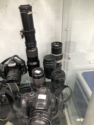 Lot 786 - Lumix and Nikon cameras, lenses and cases with...