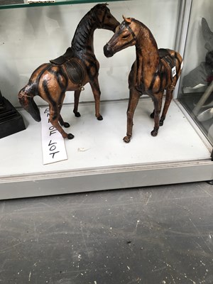 Lot 821 - A pair of leather figures of saddled horses