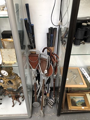 Lot 822 - A collection of golf clubs together with four...