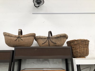Lot 876 - Two baskets with wooden strap handles together...
