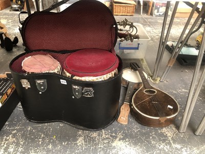 Lot 910 - A case of two tomtom drums, a banjo and a...