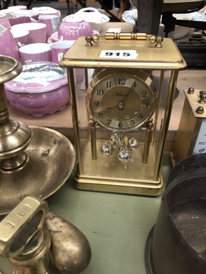 Lot 915 - A collection of brass bells, three clocks, a...