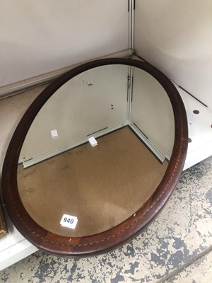 Lot 940 - A bevelled glass oval mirror within a barber's...