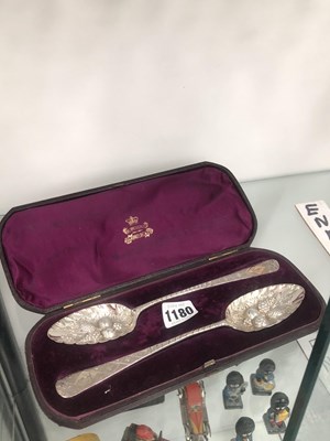 Lot 1180 - A cased pair of silver berry spoons