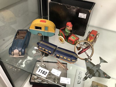 Lot 1182 - Tin plate clockwork toys, a die cast war plane
