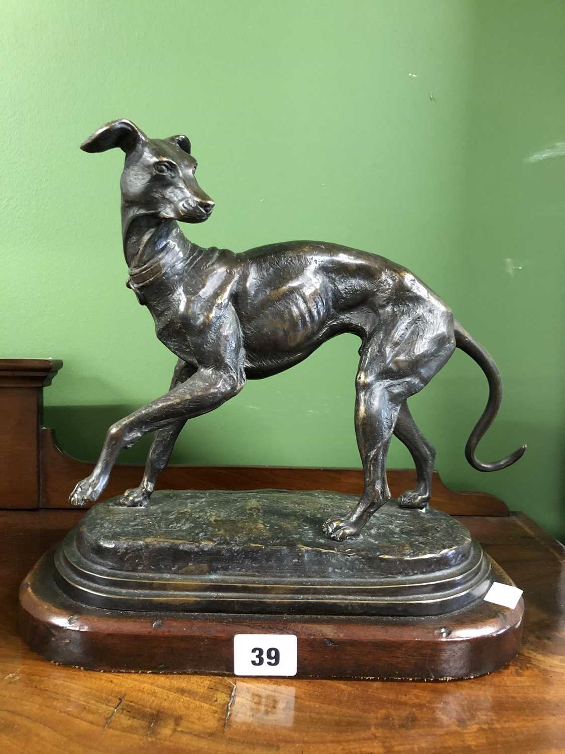 Lot 39 - Style of P J Mene, a bronze whippet poised on...